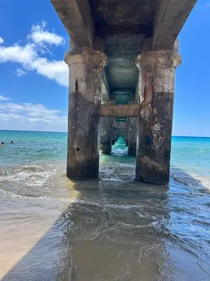 a bridge over the water under the beach at Porto Santo Rentals in Porto Santo