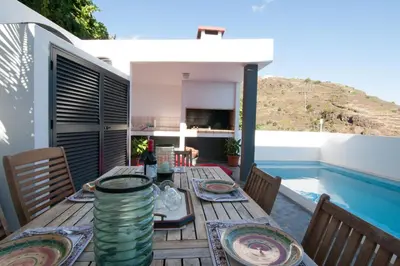 a table on the deck of a house at Casa Nici in Calheta