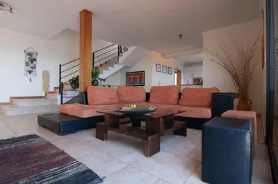 a living room with a couch and a table at Casa Nici in Calheta