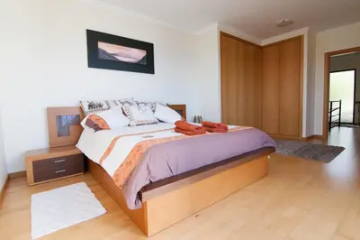a bedroom with a large bed in a room at Casa Nici in Calheta