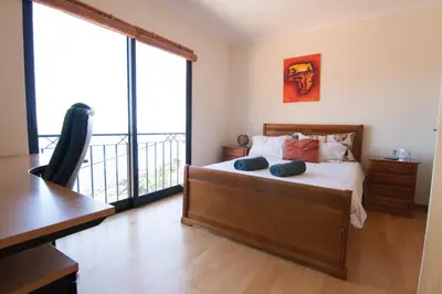a bedroom with a bed and a balcony at Casa Nici in Calheta