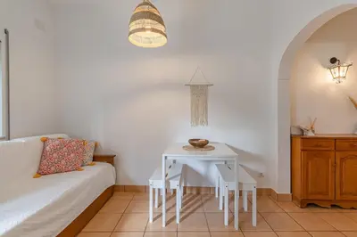 a living room with a white table and a couch at Casa da Praia Burgau in Burgau