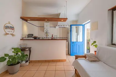 a living room with a couch and a blue door at Casa da Praia Burgau in Burgau