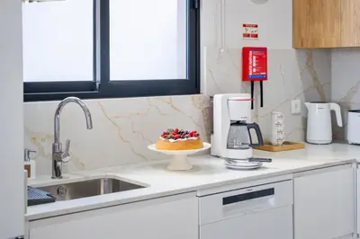 a kitchen with a cake on a plate on a counter at Orinoco Sunset House I - Private Jacuzzi in Calheta