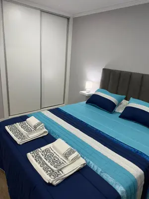 a bedroom with a blue bed and a table at Casa Camacho - Santa Cruz in Santa Cruz