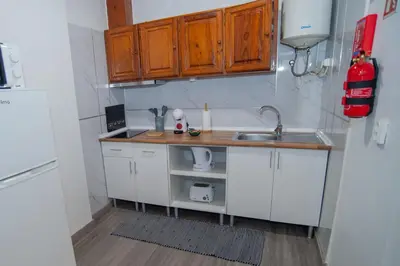 a small kitchen with white cabinets and a sink at Apartment II Estrela da Calheta in Calheta