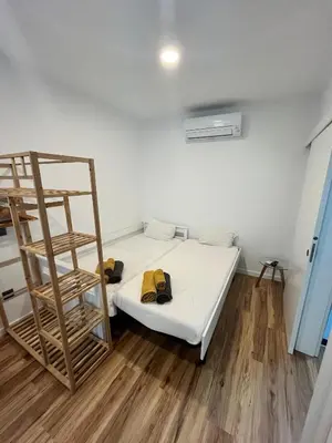 a bedroom with a bunk bed and a ladder at Modern Studio Flat in Machico in Machico