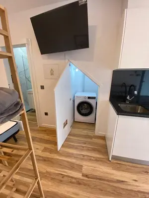 a small room with a sink and a washing machine at Modern Studio Flat in Machico in Machico