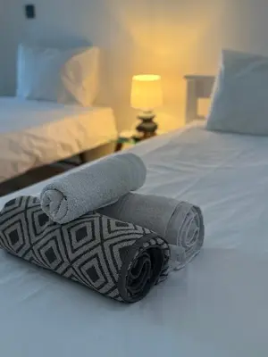 two rolls of towels laying on a bed at Modern Studio Flat in Machico in Machico