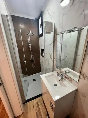 a bathroom with a sink and a shower at Modern Studio Flat in Machico in Machico