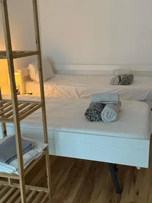 a bedroom with a bunk bed and a ladder at Modern Studio Flat in Machico in Machico
