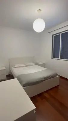 a white room with a bed and a window at Seavale Apartement in Funchal