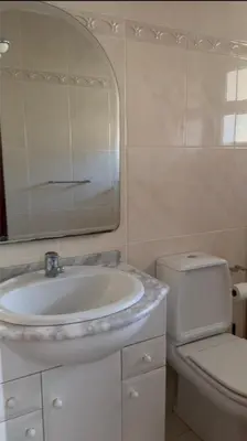 a bathroom with a sink and a toilet and a mirror at Seavale Apartement in Funchal