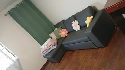 a black couch in a living room with flowers on it at Mari in Funchal