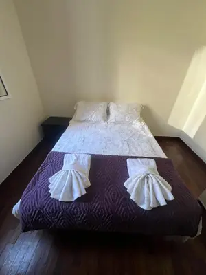 a bed with two pillows on it in a room at Mari in Funchal