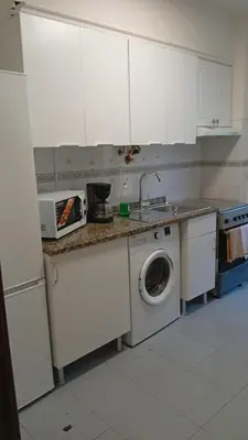a kitchen with a sink and a washing machine at Mari in Funchal