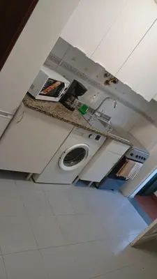 a bathroom with a sink and a washing machine at Mari in Funchal