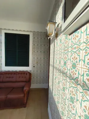 a couch sitting in a room with a wall at Três Marias - Shared Countryside Connection in Lanceiros
