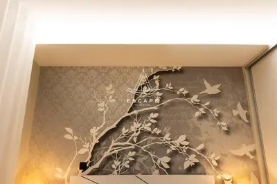 a wall mural of a tree with birds and butterflies at Lobos Dream Flat by Escape to Madeira in Câmara de Lobos