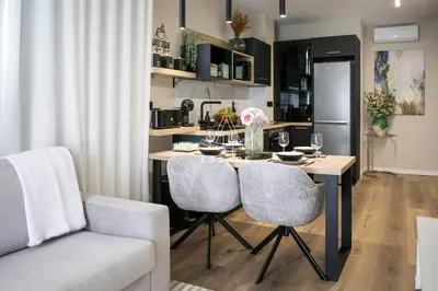 a gold lamp sitting on a table next to a bed at Lobos Dream Flat by Escape to Madeira in Câmara de Lobos