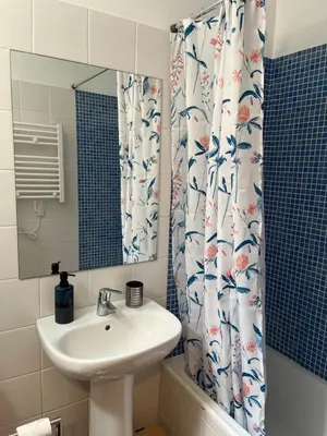 a bathroom with a sink and a shower curtain at Bella Vista in Funchal