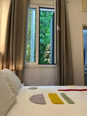 a bed with three pillows on it with a window at Bella Vista in Funchal