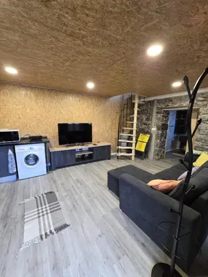 a living room with a couch and a tv at casa Farraia in Santana