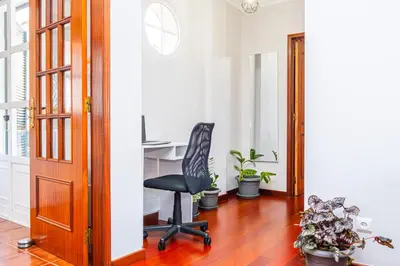 an office with a desk and a chair in a hallway at StayinMachico in Machico