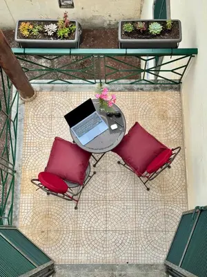 an overhead view of a table with two chairs and a laptop at StayinMachico in Machico