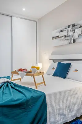 a bedroom with a bed and a table at Orinoco Sunset House II - Private Pool & Garden in Calheta
