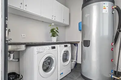 a laundry room with a washer and dryer at Orinoco Sunset House II - Private Pool & Garden in Calheta