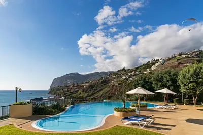 a swimming pool with a view of the ocean at Vila Formosa III by An Island Apart in Funchal