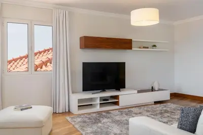 a living room with a flat screen tv on a wall at Vila Formosa III by An Island Apart in Funchal