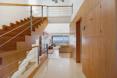 a staircase in a house with a view of the ocean at Som do Mar Luxury Ocean Front Villa in Luz