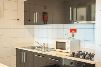 a kitchen with a microwave and a sink at Infinite Sea in Funchal