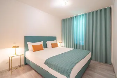 a bedroom with a large bed and a large window at Infinite Sea in Funchal
