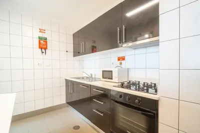 a kitchen with a stove and a microwave at Infinite Sea in Funchal