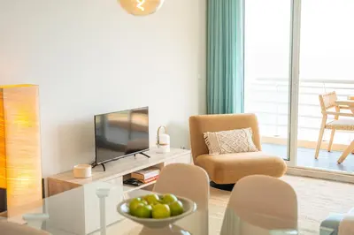 a living room with a television and a chair at Infinite Sea in Funchal