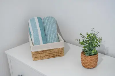 two baskets sitting on a white table with a plant at Luzia by the Sea - T1 Acolhedor a Passos da Praia in Calheta