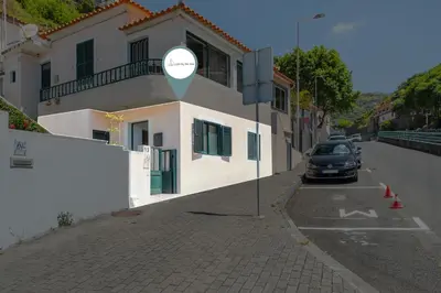 a car parked on a street next to a building at Luzia by the Sea - T1 Acolhedor a Passos da Praia in Calheta