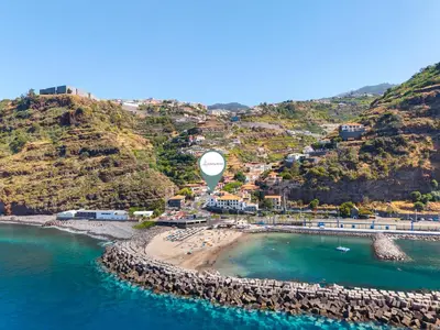 an aerial view of a beach with a hot air balloon at Luzia by the Sea - T1 Acolhedor a Passos da Praia in Calheta