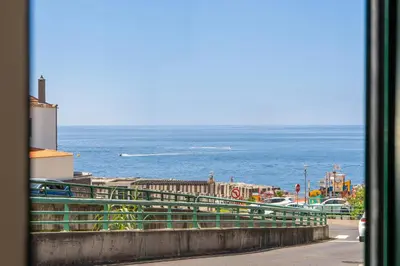 a view of the ocean from a window at Luzia by the Sea - T1 Acolhedor a Passos da Praia in Calheta