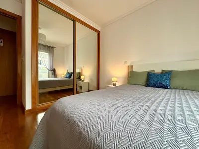 a bedroom with a bed with green pillows and a window at Pilar - rooms for rent in Funchal