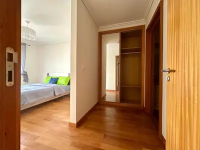 a bedroom with a bed and an open door at Pilar - rooms for rent in Funchal