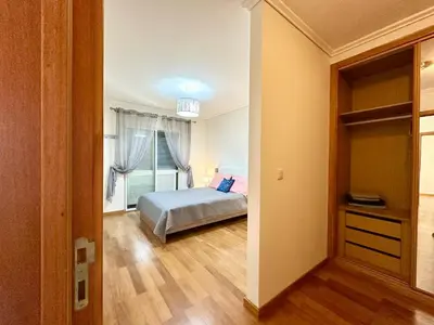 a bedroom with a bed and a large window at Pilar - rooms for rent in Funchal