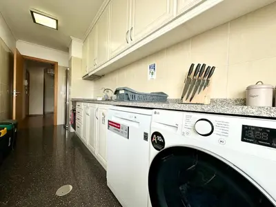 a washer and dryer in a kitchen at Pilar - rooms for rent in Funchal