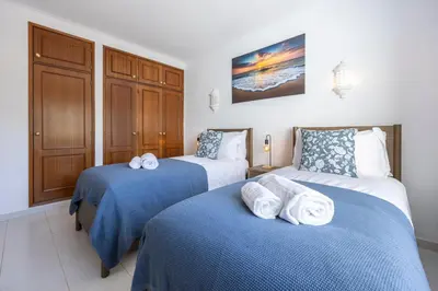 a bedroom with two beds with towels on them at Apartment do Ramses in Luz