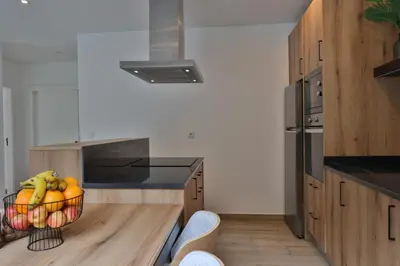 a kitchen with a bowl of fruit on a table at Refúgio da Ribeira in São Vicente
