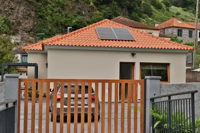 a house with a solar panel on the roof at Refúgio da Ribeira in São Vicente