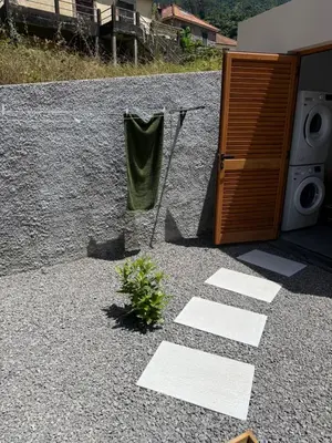 a door to a house with a towel on the ground at Refúgio da Ribeira in São Vicente